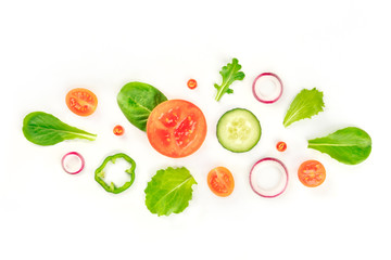 Fresh vegetable salad ingredients, shot from the top on a white background. A flat lay composition with tomato, cucumber, peppers, onion slices and mezclun leaves