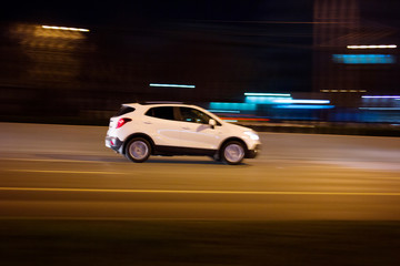 Obraz na płótnie Canvas The car rushes on the highway at high speed Photo taken from the roadside ,Moscow, spring 2019, sky, car, road 
