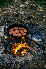 Grilled sausages on a campfire
