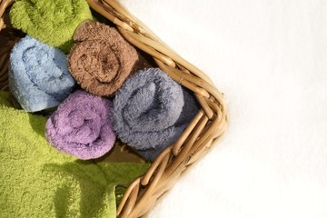 Fototapeta na wymiar double colored terry towels folded woven square basket