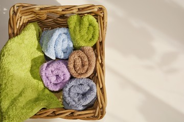 Fototapeta na wymiar double colored terry towels folded woven square basket