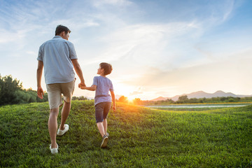 Father and son on meadow