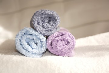 Obraz na płótnie Canvas terry colorful towels folded in rollsterry colorful towels folded in rolls