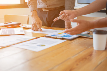 man holding pen to point in paperwork, business meeting concept