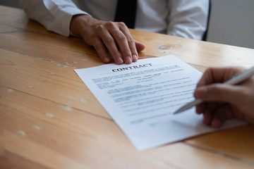 business partners signing a contract