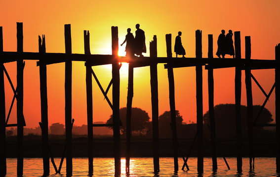 Monks crossing the U-Bein bridge at sunset, Amarapura, Myanmar (Burma)
