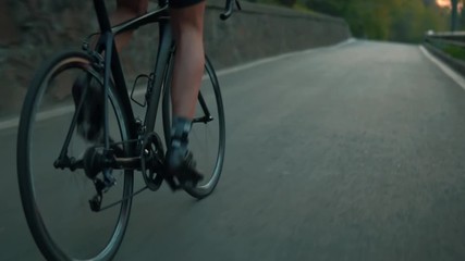 Cyclist Legs Cycling Slow Motion On Bicycle.Cyclist Legs.Close Up Strong Legs Bicyclist.Close Up Cyclist Focus On Muscular Legs Pedalling Bicycle In Uphill.Tracking Shot Cyclist Legs Foot