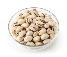 Salted pistachios in glass bowl isolated on white background with clipping path