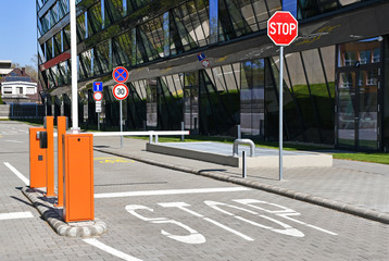 Parking lot gate and stop sign next to an office building