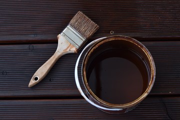 Brush with paint on wooden floor © mZeee