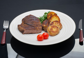 Grilled steak with vegetables and rosemary top view on white