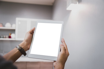 Mockup tablet on businessman hands empty display on home table with blur background. - Image - Image