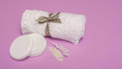 beauty set with body cream on a violet background