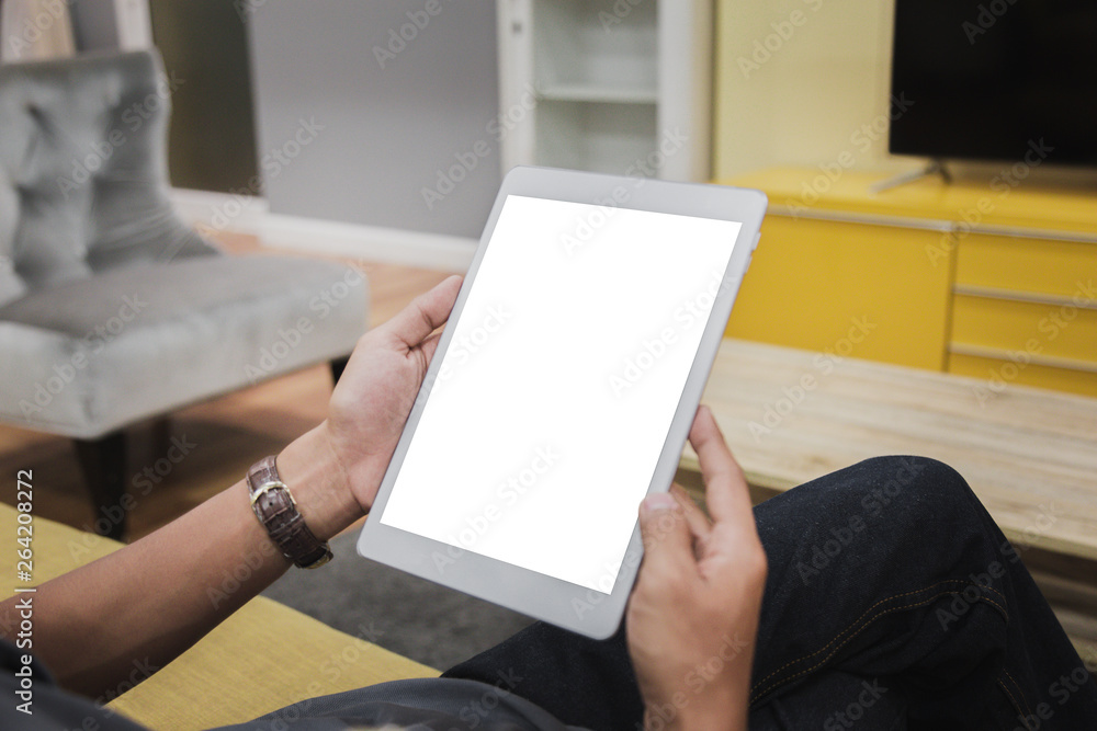 Wall mural mockup tablet on businessman hands empty display on home table with blur background. - image - image