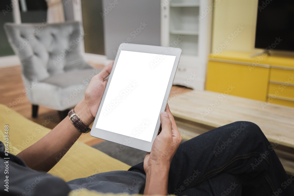 Wall mural mockup tablet on businessman hands empty display on home table with blur background. - image - image