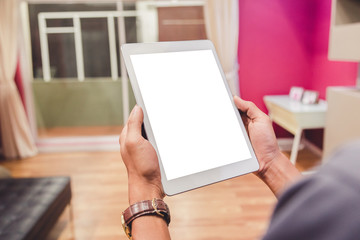 Mockup tablet on businessman hands empty display on home table with blur background. - Image - Image