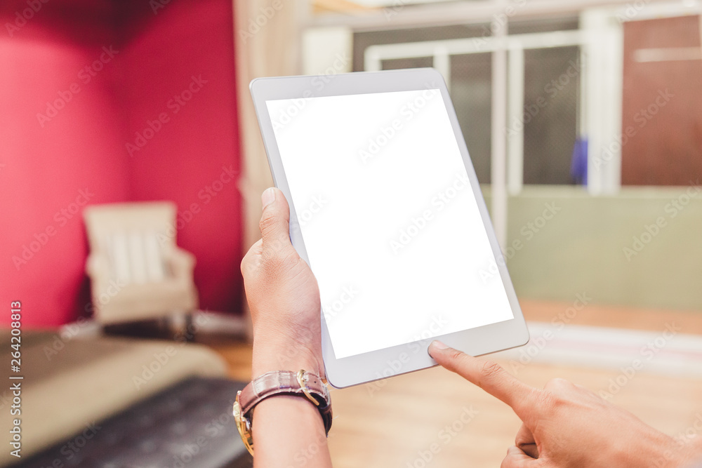Wall mural mockup tablet on businessman hands empty display on home table with blur background. - image - image