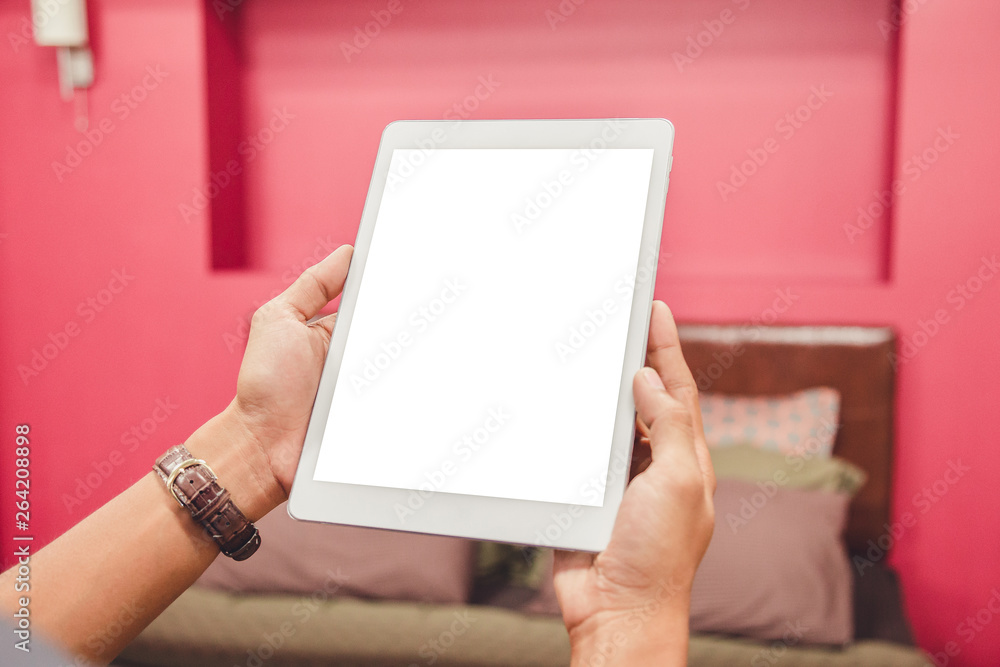 Wall mural mockup tablet on businessman hands empty display on home table with blur background. - image - image