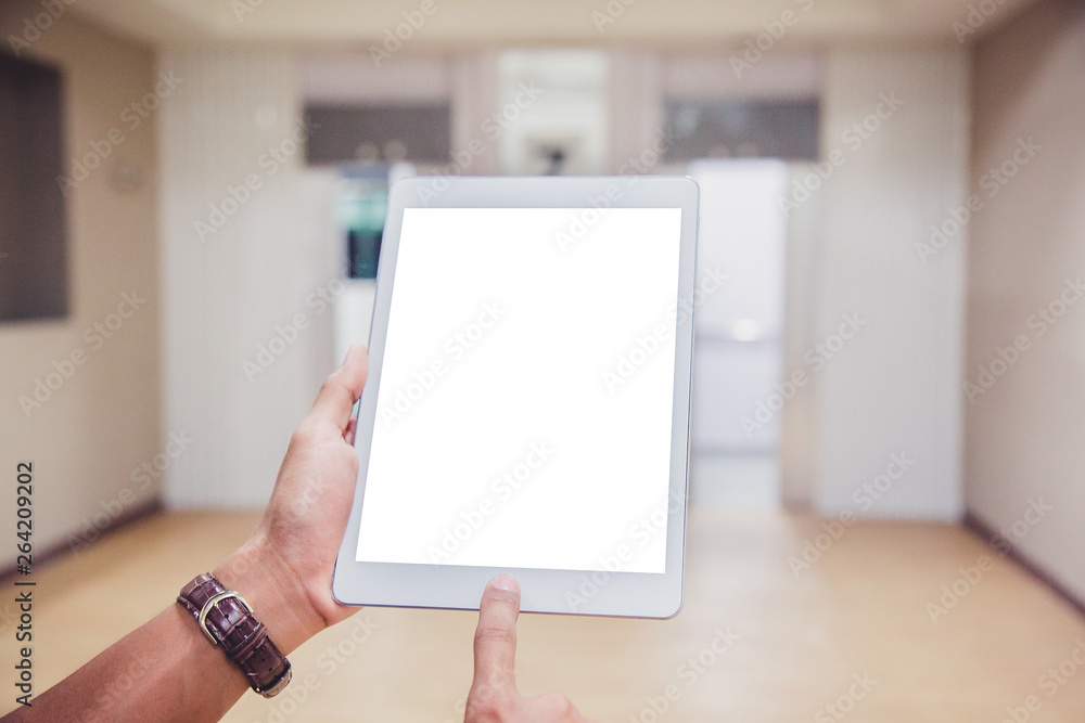 Sticker mockup tablet on businessman hands empty display on home table with blur background. - image - image