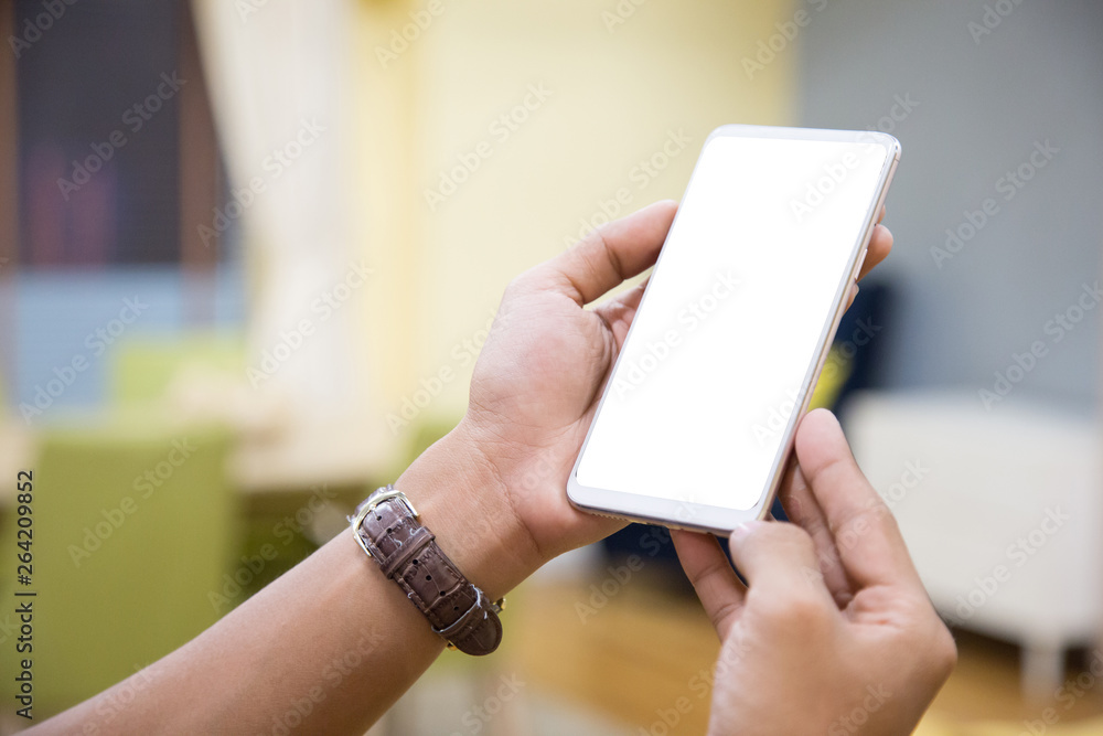 Wall mural mockup smartphone on businessman hands empty display on home table with blur background. - image - i