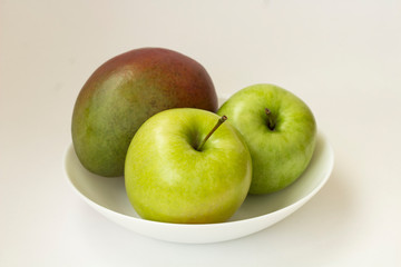 Apple and mango on white background