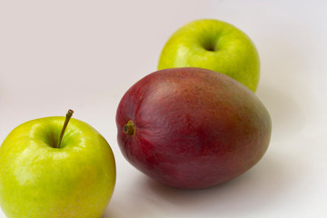 Apple and mango on white background