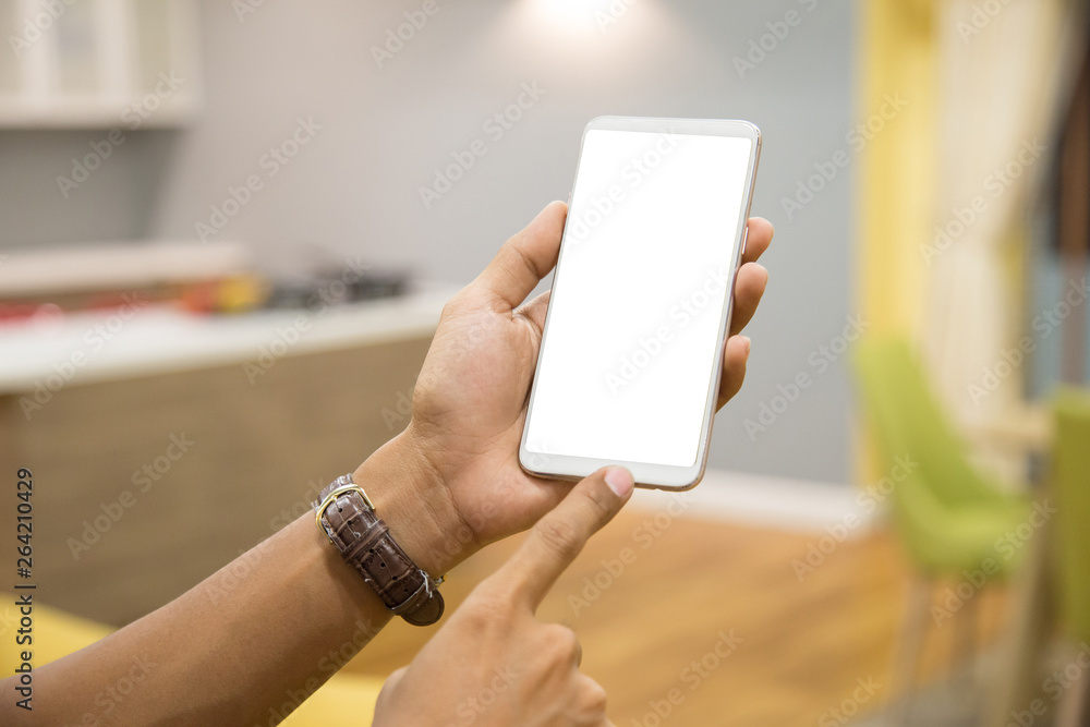 Wall mural mockup smartphone on businessman hands empty display on home table with blur background. - image - i