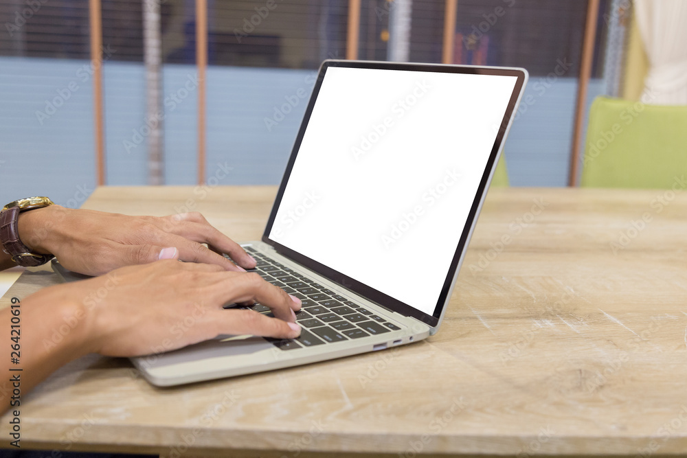 Wall mural mockup image of a businessman using laptop with blank white desktop screen working in home- image