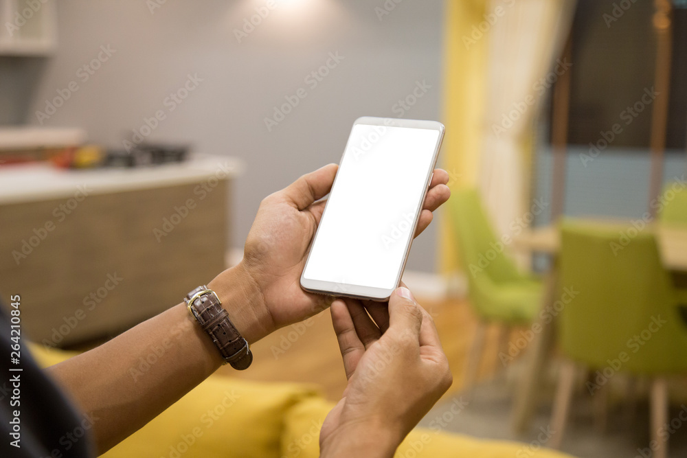 Poster mockup smartphone on businessman hands empty display on home table with blur background. - image - i