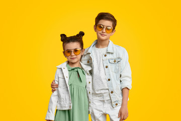 Stylish kids hugging and looking at camera