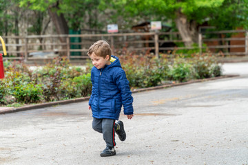 Fototapeta premium Small child running in a park