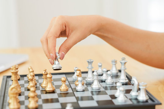 Hand of woman playing chess
