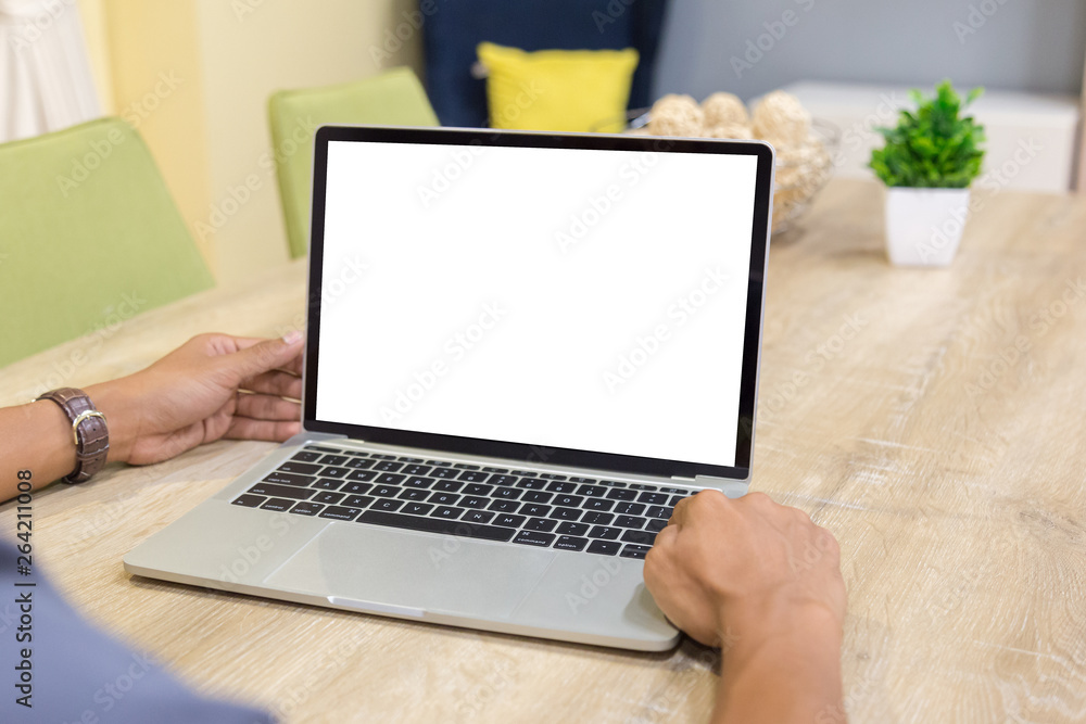 Wall mural mockup image of a businessman using laptop with blank white desktop screen working in home- image