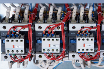 A number of electrical contactors with additional contacts installed in the electrical Cabinet....