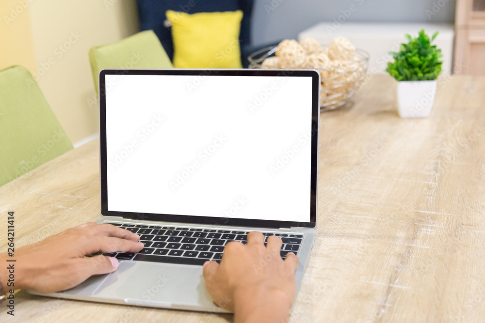 Wall mural mockup image of a businessman using laptop with blank white desktop screen working in home- image
