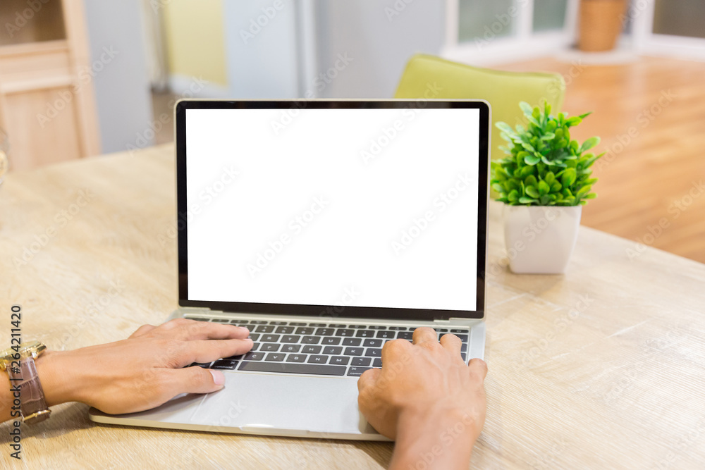 Sticker mockup image of a businessman using laptop with blank white desktop screen working in home- image