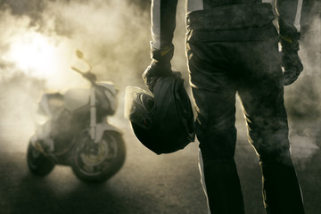 Fototapeta Motorradfahrer und Motorrad stehen im Rauch obraz