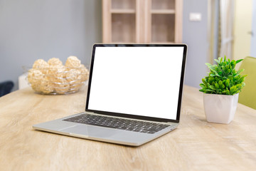 Fototapeta premium laptop showing blank screen on work table front view in home- Image
