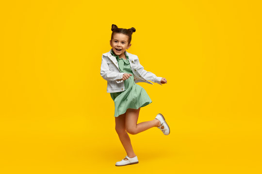 Stylish child smiling and dancing
