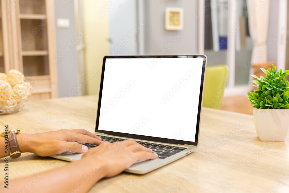 Poster mockup image of a businessman using laptop with blank white desktop screen working in home- image