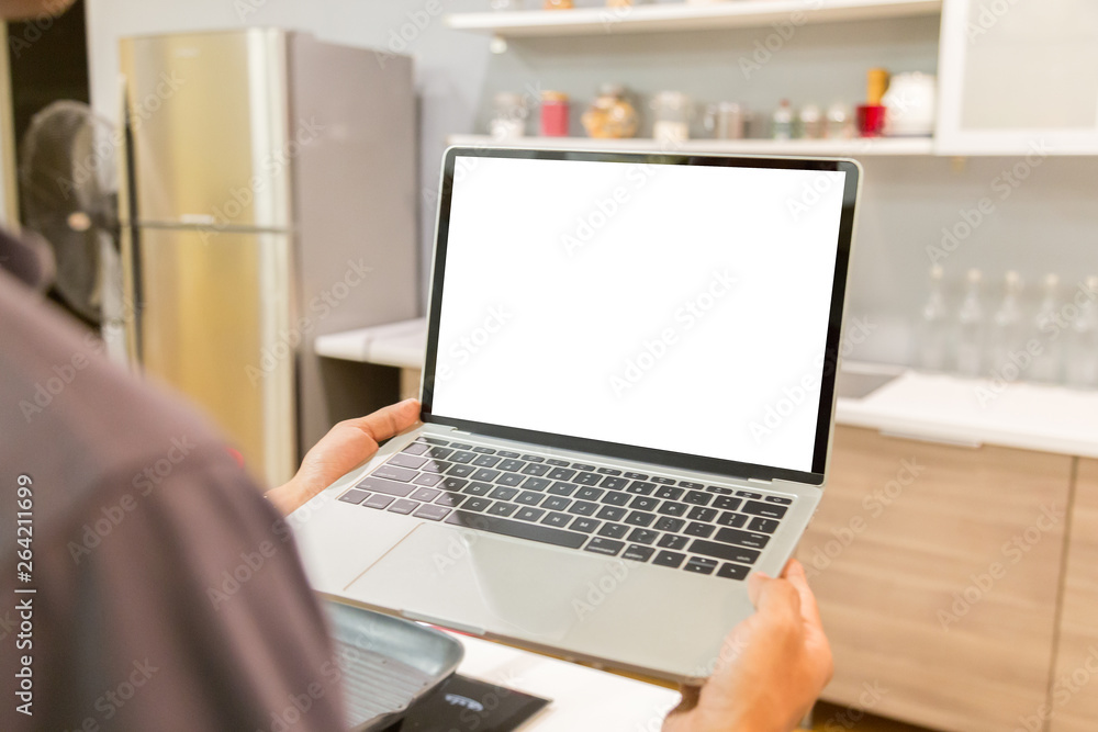 Sticker mockup image of a businessman using laptop with blank white desktop screen working in home- image