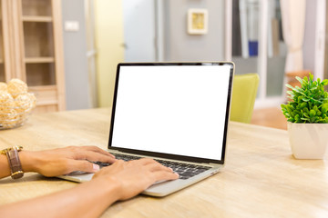 Mockup image of a businessman using laptop with blank white desktop screen working in home- Image