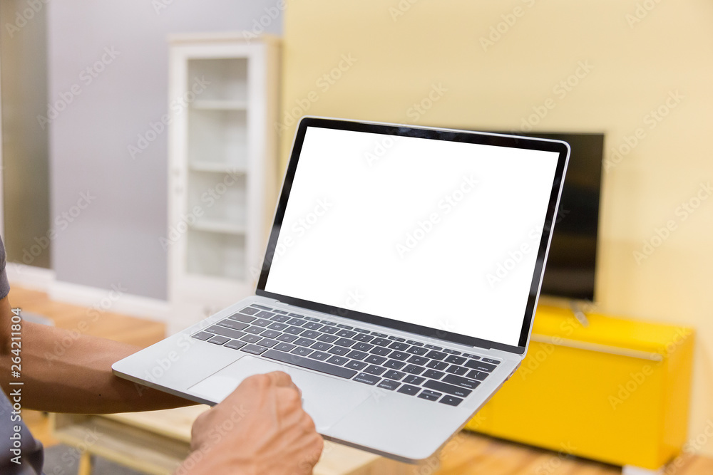 Sticker mockup image of a businessman using laptop with blank white desktop screen working in home- image