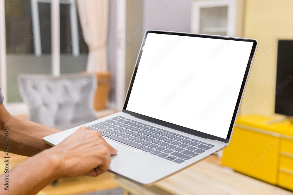Sticker mockup image of a businessman using laptop with blank white desktop screen working in home- image