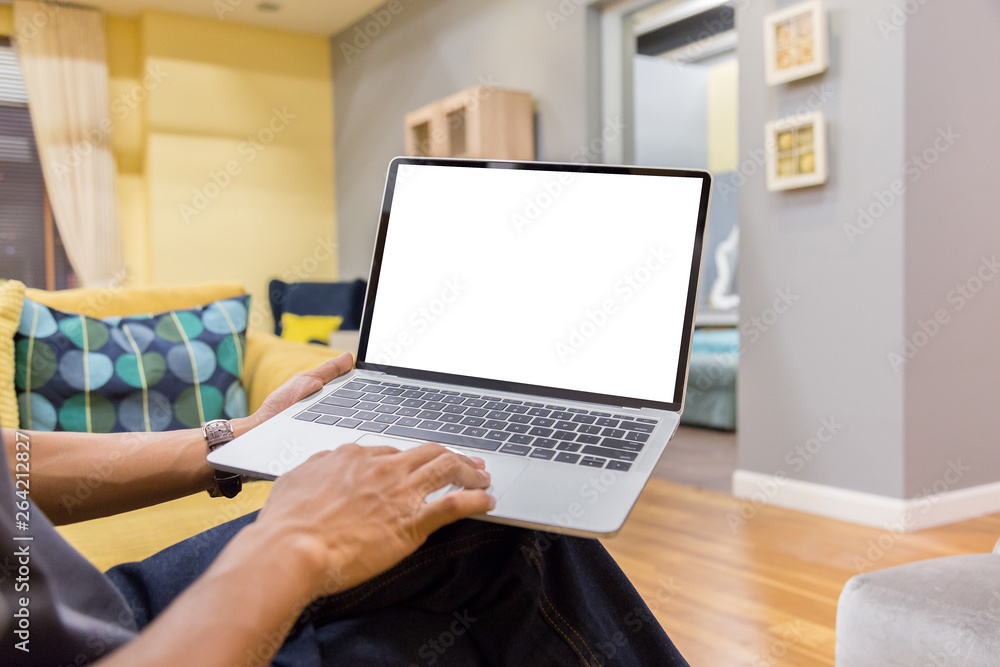 Sticker mockup image of a businessman using laptop with blank white desktop screen working in home- image