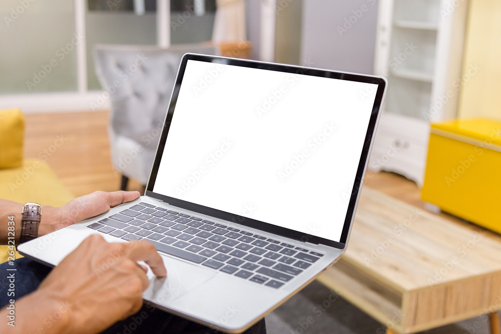 Sticker mockup image of a businessman using laptop with blank white desktop screen working in home- image