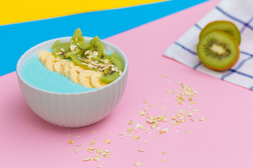 fresh fruit on a colored background. Colorful fruit pattern of fresh kiwi slices on colored background. From top view.