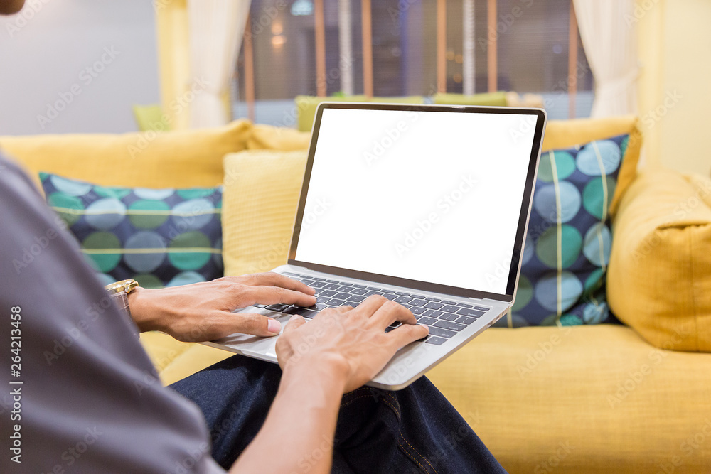 Wall mural mockup image of a businessman using laptop with blank white desktop screen working in home- image