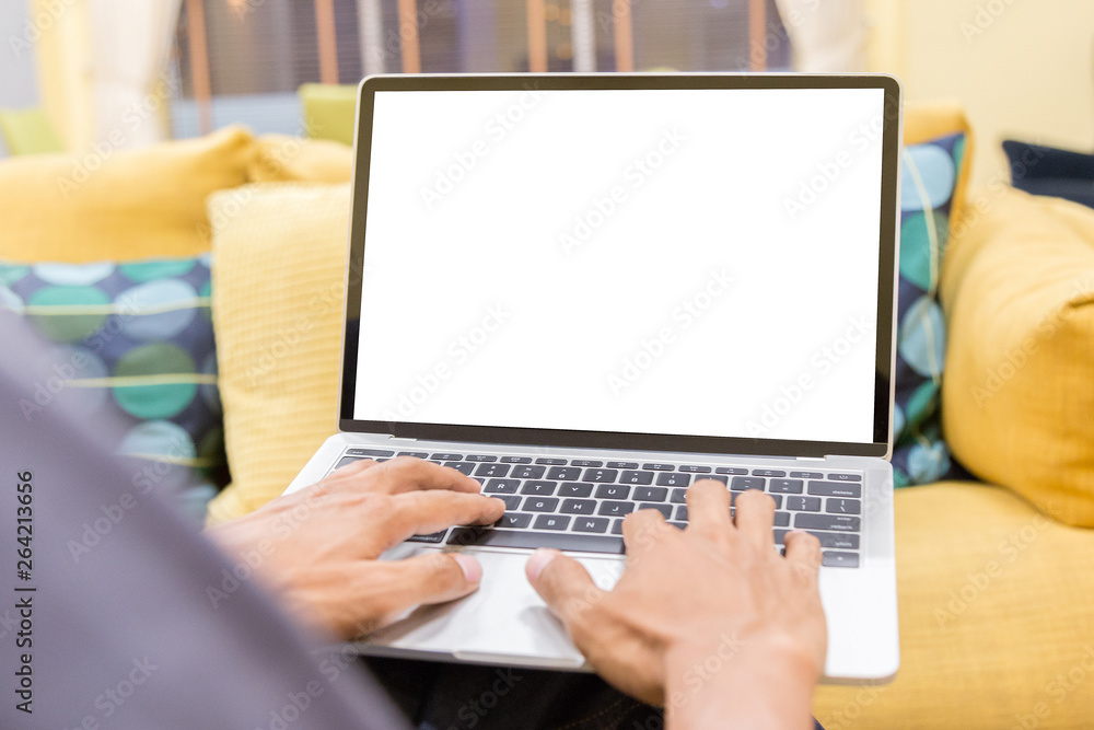 Sticker mockup image of a businessman using laptop with blank white desktop screen working in home- image