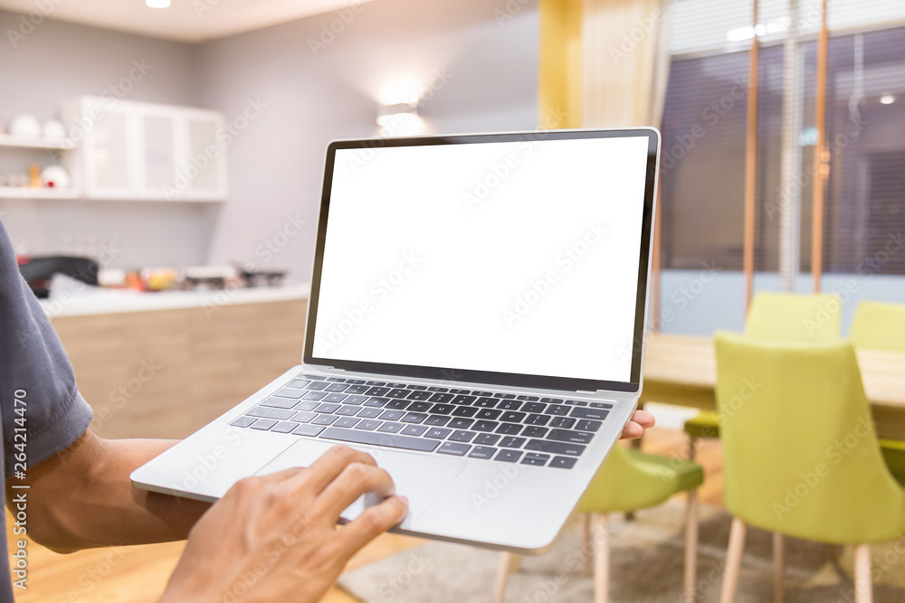 Poster mockup image of a businessman using laptop with blank white desktop screen working in home- image